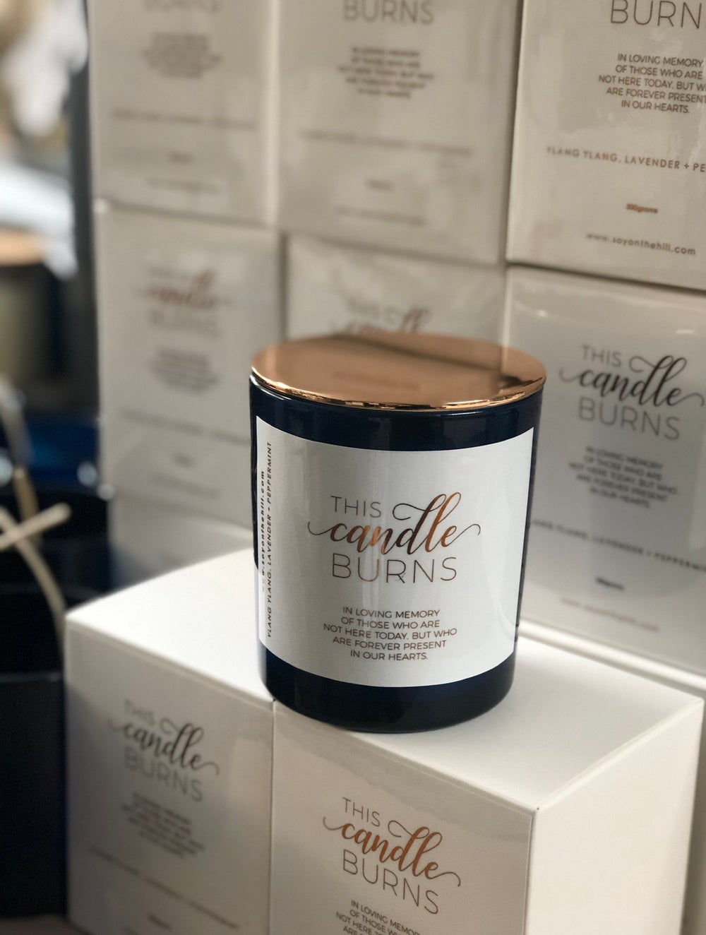 THIS CANDLE BURNS -SANDLEWOOD, PATCHOULI & VANILLA